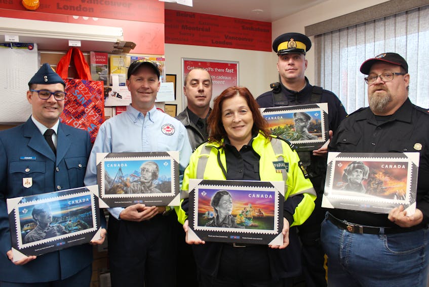 First responders from P.E.I. show plaques depicting five new stamps from Canada Post’s “Tribute to Canada’s Best and Bravest” series during a ceremony at the Crapaud Post Office recently. Along with the stamps honouring the country’s first responders, 15 thousand plaques were also made and are being handed out to emergency responders in various communities. From left, is Canadian Armed Forces aviator Craig Court, Doug MacDonald of the Civil Air Search and Rescue Association, Crapaud fire chief Chris Paynter, paramedic Annie MacPhee, RCMP Cst. Dave Brown and Victoria fire captain Kent Cooke.