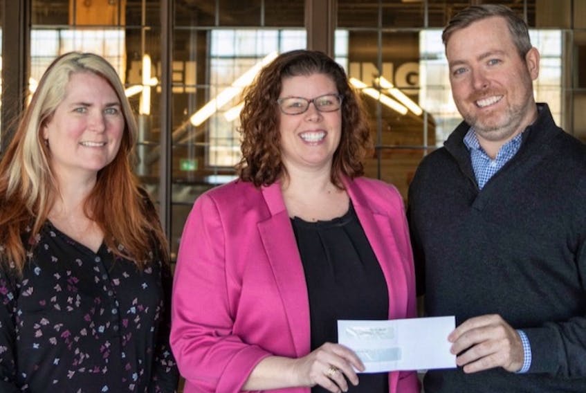 Victoria Taylor, left, and Lisa Thibeau, both of Health P.E.I., accept a cheque from Ben Murphy of Murphy Hospitality Group.
