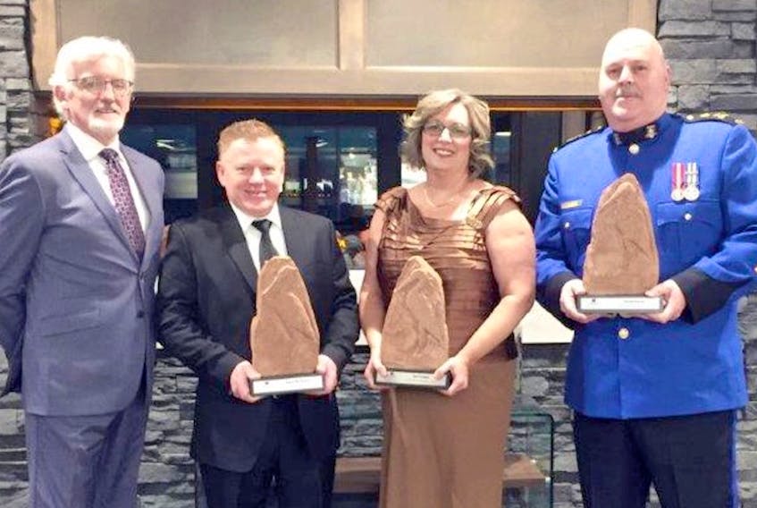 Holland College president Sandy MacDonald, left, makes a presentation to the 2018 Holland College Distinguished Alumni Award recipients, including chef Irwin MacKinnon, Jan Cowper and Chief David Poirier. MacKinnon, a celebrated chef with Papa Joe's restaurant in Charlottetown, has been honoured with numerous regional and national awards. Cowper, a graduate from the college’s dental assisting program, is the team leader of federal programs for the Medical Authorization Centre-Dental for Medavie Blue Cross in Moncton. Poirier has been chief of police for the City of Summerside since 2006 and, in 2017, was awarded the Canadian Police Exemplary Long Service Medal for 40 years of distinguished service.