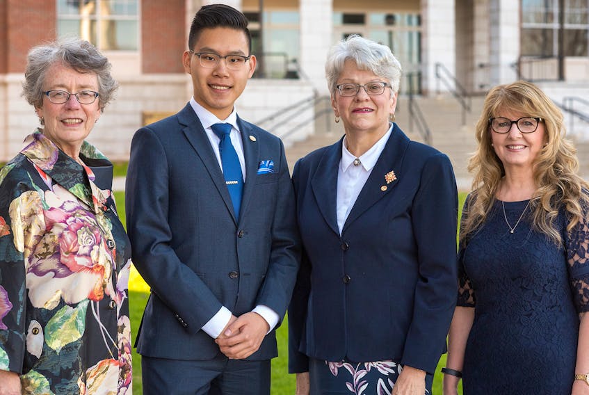 Dignitaries congratulate gold recipient Chris Zhou following the bronze and silver award Duke of Edinburgh ceremony held recently at the Centre for Community Engagement, Holland College. From left are Susan Willis, deputy minister of education, early learning and culture, Lt.-Gov. Antoinette Perry and president Nora MacEwen.