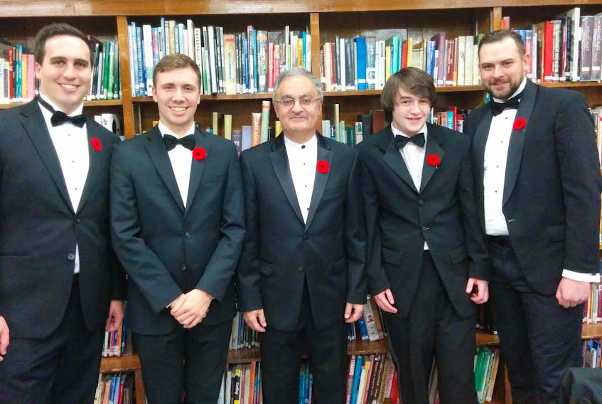 Conductor Karem J. Simon, third left, meets with featured soloists in the Nov. 15 recital of the UPEI Wind Symphony at the Homburg Theatre of the Confederation Centre of the Arts at 7:30 p.m. Branden Kelly, Ryan Drew, Karem J. Simon (conductor), Kendall Perry, Michael Gallant.