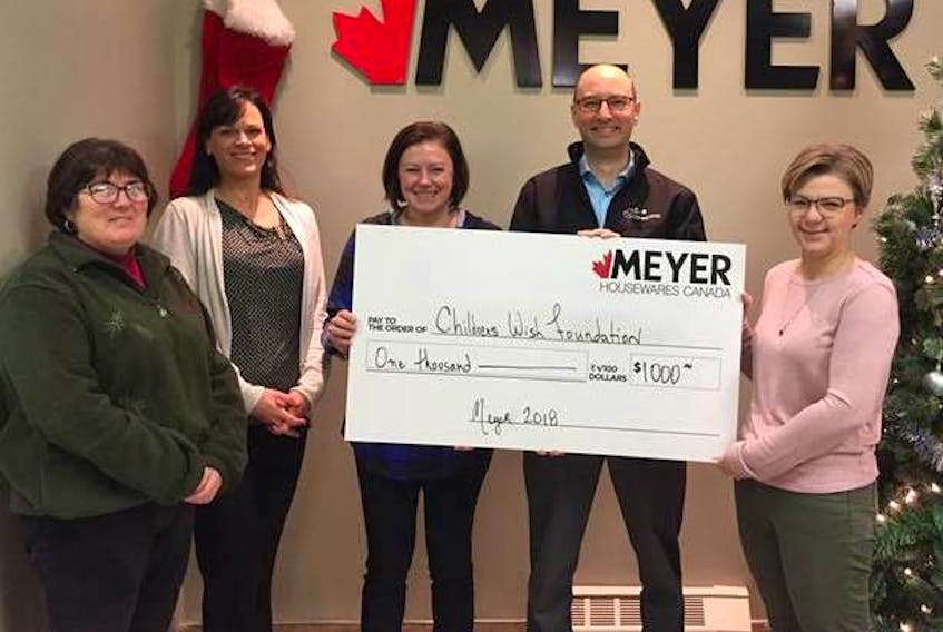 Darryl Warren, development co-ordinator of Children’s Wish Foundation’s P.E.I. chapter, second right, accepts a $1,000 donation from Meyer Houseware. The Charlottetown operation is represented, from left, by Jackie Van Dyk, Tanya Cannon, June Isaac and Jean Sinclair.