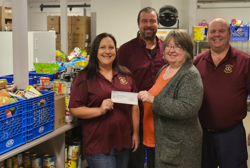 Brenda Moore, right, of the Upper Room Hospitality Ministry accepts a cheque for $1,000 from Winsloe Lions members; from left, Michelle Lamont, Jason Lamont and Lyndon Mayhew.