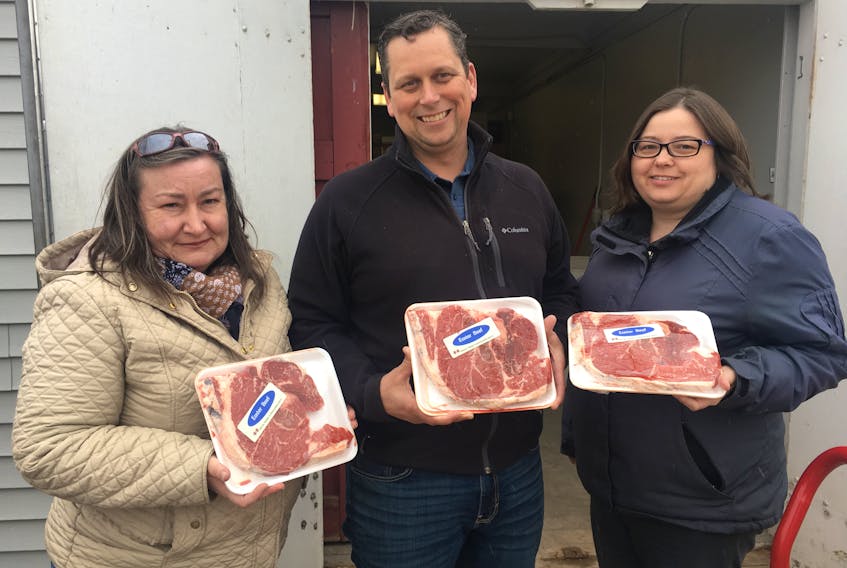 Anne MacPhail, left, and Erin Miller-Jones, right, representing Agriculture Union Local 90004 recently made a donation of beef from a 1,064-pound steer bought at the Easter Beef sale to Mike MacDonald, Upper Room food bank. Taking part in this event has become part the union’s annual tradition of giving back to the community.