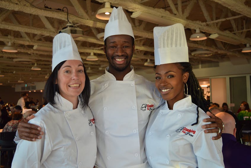 Holland College team members Lori-Beth Dwyer, left, volleyball coach, Ibra Sanoh, soccer athlete, and Philicia Johnson, volleyball athlete, were part of the winning team during the second annual Cooking for KidSport fundraiser at the Culinary Institute of Canada in Charlottetown.