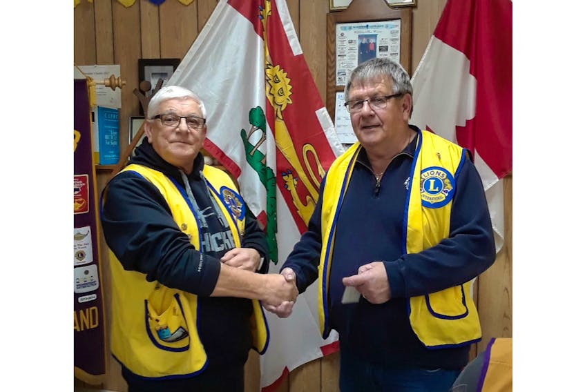 Summerside King Lion Edwin Gallant, left, presents Lion Roger Richard with the Gold Centennial Membership Award. The presentation took place at a recent meeting.