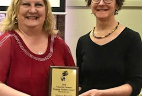 Nancy Russell, left, receives the Honorary Life Membership Award from Colleen Walton, president of Farmers Helping Farmers. - Submitted photo