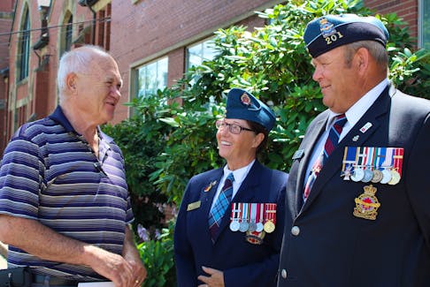 Ted Grant, left, of Mikinduri Children of Hope, chats with Debbie Reid, president of the 201 Confederation Wing RCAF Association, and Dan Miller, past-president, after accepting a cheque for $11,500 from the association, which raised the money though a cash lottery in partnership with Mikinduri. Grant said the funds will go toward the construction of a new classroom in Kenya, along with an ecosan toilet, which is more efficient at recycling waste.