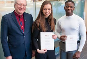 Premier Wade MacLauchlan, left, congratulates UPEI students Lorelei Kenny and Damilola Emmanuel on winning MacLauchlan Prizes for Effective Writing. Kenny and Emmanuel were among 49 students awarded the prizes at a ceremony held at UPEI on Jan. 25.