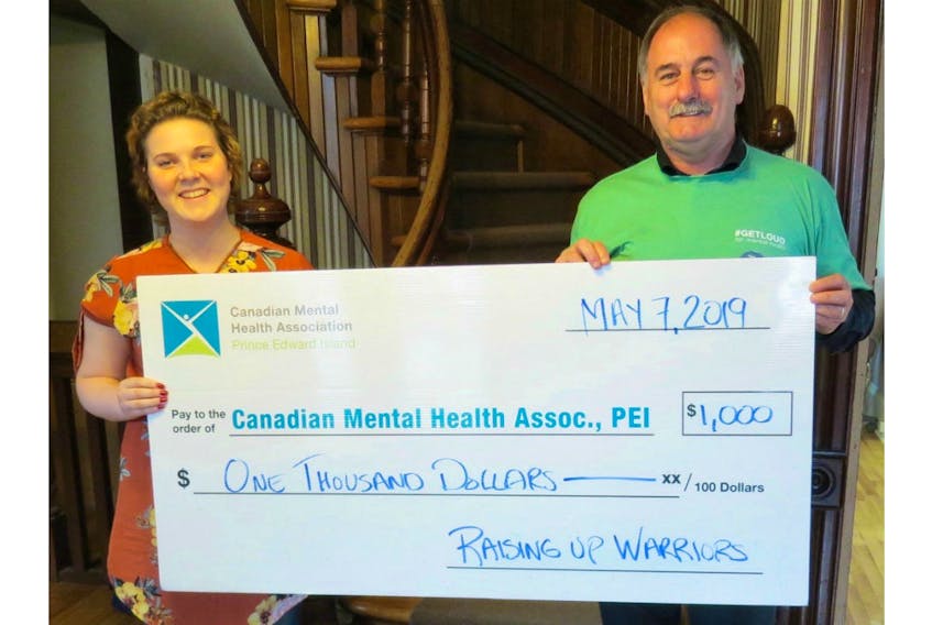 The second annual Raising Up Warriors event was held on May 4 with a portion of the event's fundraising sales donated to the Canadian Mental Health Association, P.E.I. (CMHA). Pictured are Breanna Ching, event organizer, and Reid Burke, executive director, CMHA.