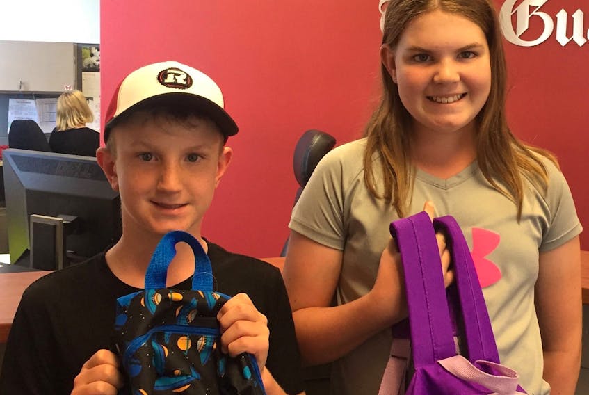 Timothy Ferguson, 8, and Martha Ferguson, 11 of Charlottetown make their first donation ever to The Guardian’s Stuff for Students program. There are still a couple of days to drop off school supplies for young Islanders who will be going back to classes in a few weeks. The last day to contribute to this annual campaign is Friday, Aug. 24.