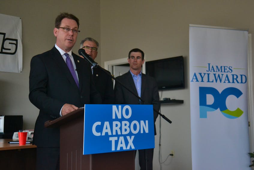 PC Leader James Aylward, flanked by fellow MLA’s Colin LaVie and Sidney MacEwen, pledges to fight any imposition of a carbon tax at a press event on Thursday.
