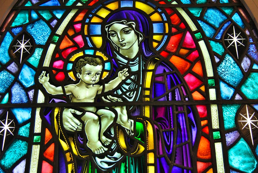 This stained glass window shows Mary holding her son, Jesus.
