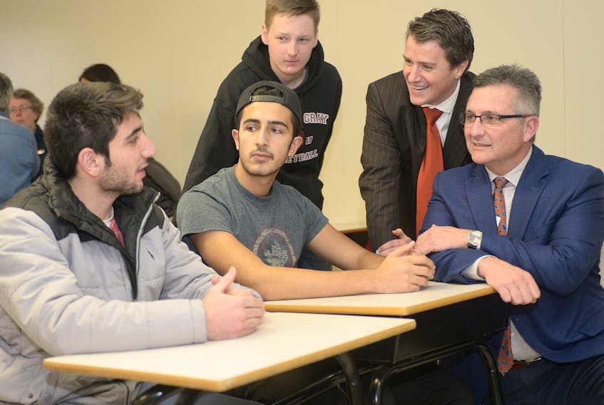 Economic development minister Heath MacDonald, from right, and education minister Jordan Brown chat with Colonel Gray students Marcell Kiss, Nour Aldwery and Mohammad Dabbit following a funding announcement Wednesday. MITCH MACDONALD