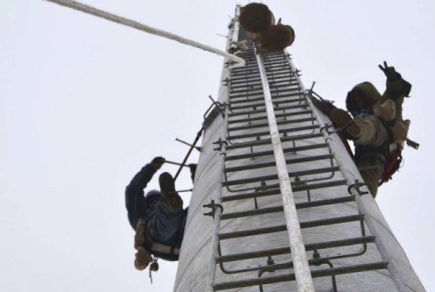 Aerial riggers work on a section of an Eastlink cell tower in Sydney Mines, N.S., in this file photo.