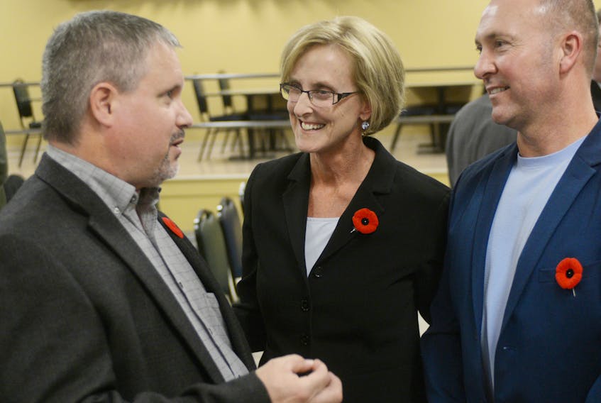 Melissa Hilton, centre, and her husband, Rob, right, speak with supporter Gardiner MacNeill after being acclaimed as the Progressive Conservative candidate for the District 11 byelection during a nomination meeting Wednesday night. Other candidates include Bob Doiron for the Liberal party and Hannah Bell for the Green party. The provincial NDP has yet to nominate a candidate. MITCH MACDONALD/THE GUARDIAN