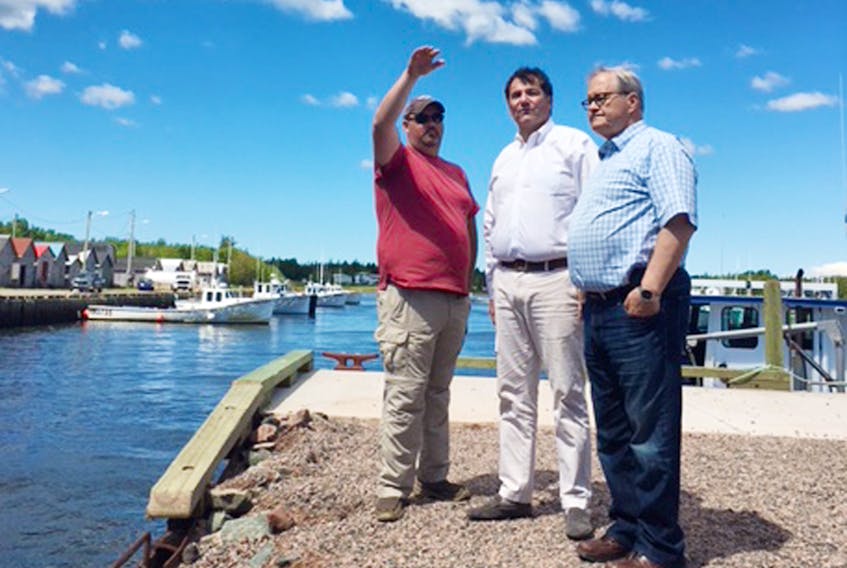 Caridgan MP Lawrence MacAulay, from right, and Dominic LeBlanc, Minister of Fisheries, Oceans and the Canadian Coast Guard chat with Port Chair D.J. Bears during a funding announcement for Graham’s Pond Harbour upgrades last week.