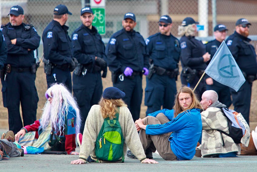 Halifax Regional Police officers form a line as climate protesters blockade of the Macdonald bridge in Dartmouth on Oct. 7, 2019. - Tim Krochak