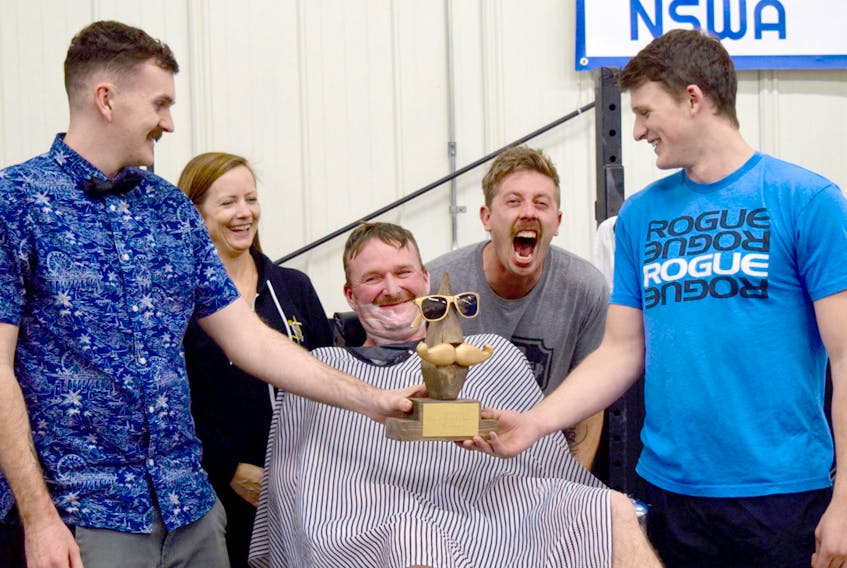 A custom-made trophy was offered for the winner of Crossfit Hubtown’s moustache-growing contest, which was presented to Jevan McNutt, right, who had shaved off his moustache before the event. From left, James Ackerman, Michelle Webber, Troy Sutherland, Christ Tufts and McNutt. Cody McEachern/Truro Daily News