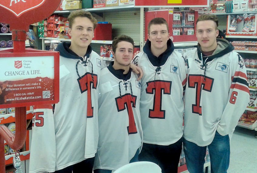 Pictured above during a shift change to man the Salvation Army Christmas Kettle at the Walmart store are, from left, Alec MacDonald, Gavin Hart, Craig Ryan and Tyler Pyke. As elder statesman, Pyke is obviously ensuring the Bearcats’ rookies are aware of their responsibilities. Submitted