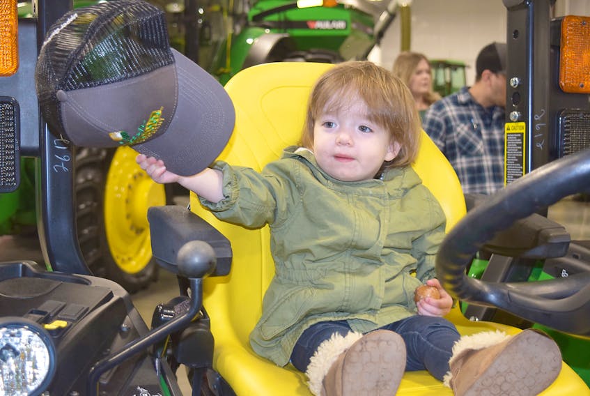 Anneke MacGillivray, 19 months, from Antigonish, enjoyed being in the driver’s seat at Green Diamond Equipment Ltd. in Upper Onslow. The John Deere dealership opened its doors during a customer event on Friday at the Upper Onslow business and held an open house for the public on Saturday.