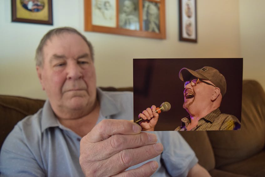 Rod Norrie, a founding member of the once-popular Truro band the Lincolns, holds up a picture of the group's former lead singer Frank MacKay, who died on March 6, 2019 following major heart surgery. The picture was taken while MacKay was singing during a Lincolns' reunion held at the Royal Canadian Legion in Truro in September 2018.