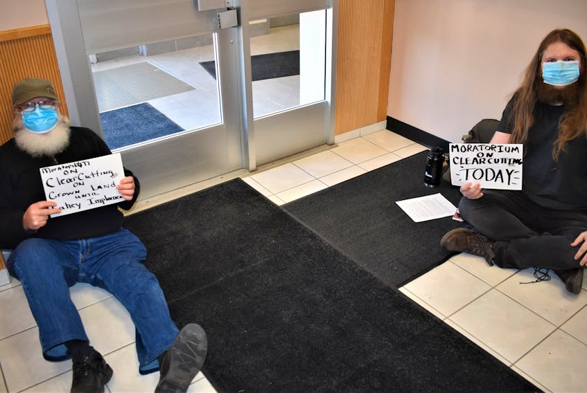 As part of the clearcutting sit-ins, Paul Jenkinson (left) and Tristan Smith sit in the entrance way to the Department of Lands and Forest office in downtown Truro.