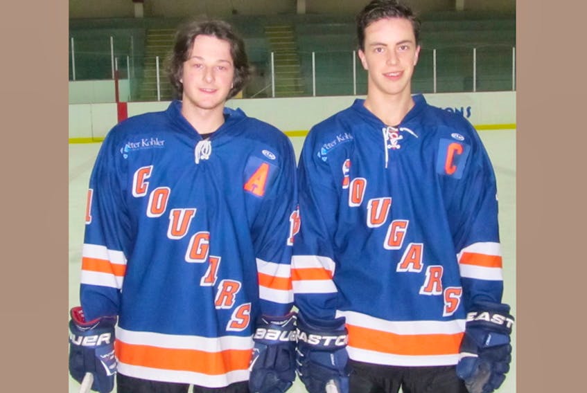 Connor Miller, left, and Luke Smith are key members of the CEC Cougars hockey team.