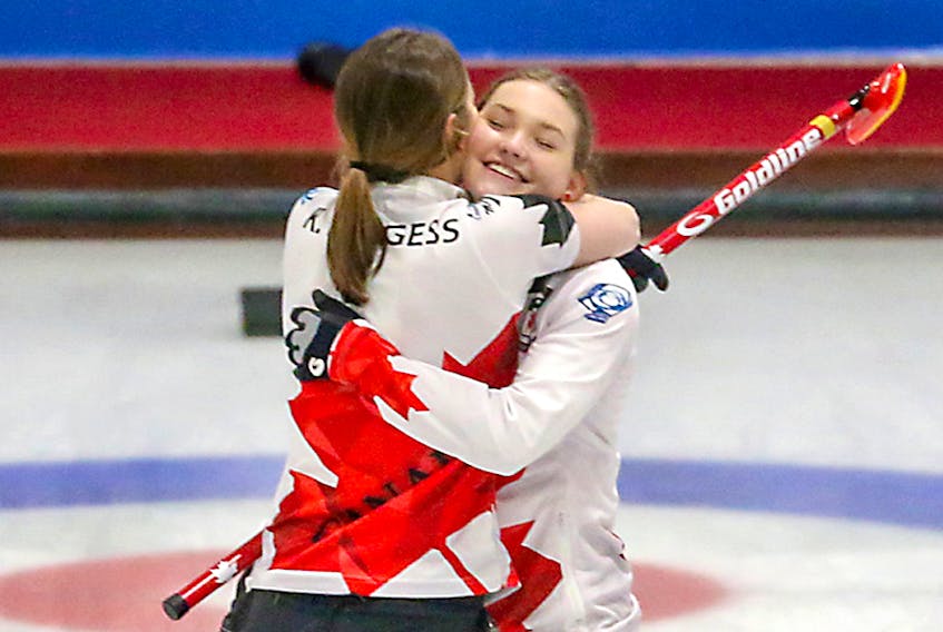 Cousins Karlee, left, and Lindsey Burgess hug following Team Canada's semifinal win over China on Friday at the world junior women's curling championship. Richard Gray/World Curling Federation