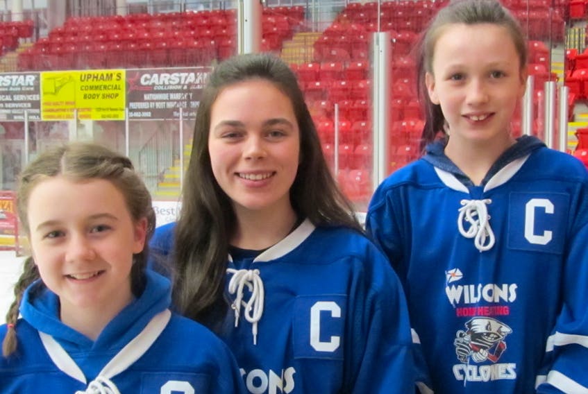 Raylee Hendsbee, left, Holly Masters and Trinity Fancy are captains with Wilsons Home Heating Cyclones hockey teams.