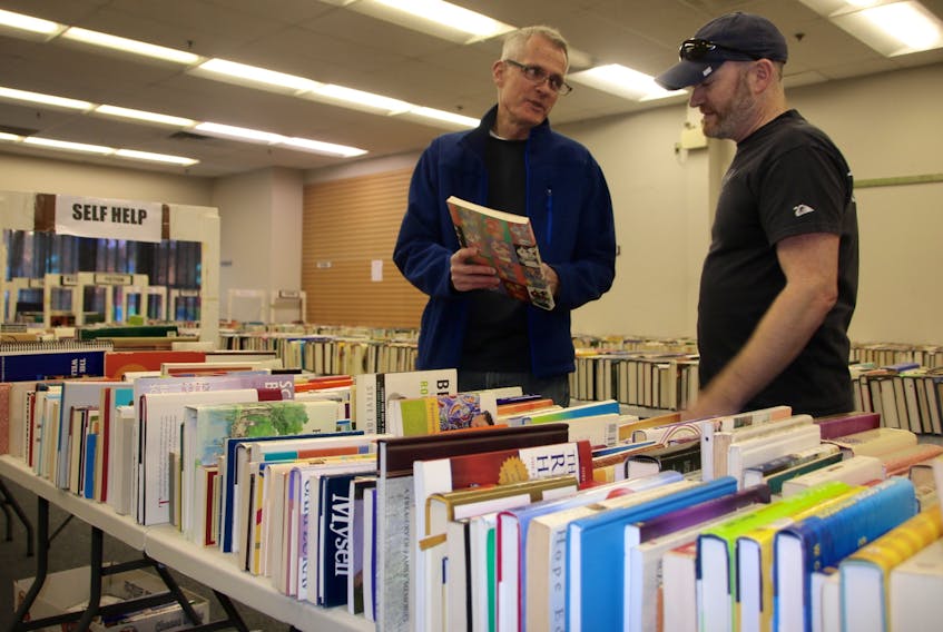 Bible Hill Kinsmen Brent Pettis, left, and Perry Kohler have been busy putting books in place for the upcoming sale. The book fair is being held in the Truro Mall  May 10 from 6 to 9 p.m. and May 11 from 9 a.m. to 4 p.m.