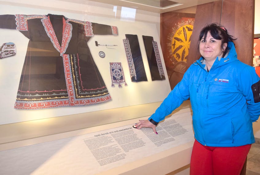 Heather Stevens, Millbrook Cultural and Heritage Centre’s operations supervisor, stands beside a display containing an image of Mi’kmaq regalia from the 1800s. The original robe remains in the possession of a museum in Australia.