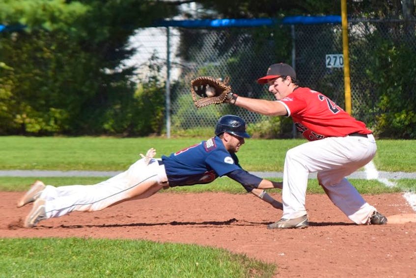 Chris Farrow of the Sydney Sooners manages to get back to the bag just before Truro Bearcat Dan Bates can put the tag on him during a pick-off attempt in Saturday’s NSSBL playoff game in Truro. The Sooners thumped the Bearcats 13-2 to go up 2-0 in the best-of five semifinal series.