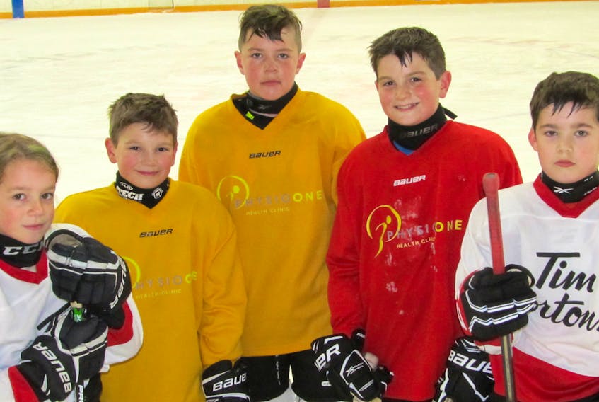 Following a recent practice, minor hockey players pause at the sportsplex in Brookfield. From left, Drew Leslie, Rigby vanTassell, Mathew O’Hara, Broden vanTassell and Julian Rushton.