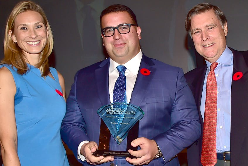 Truro's Arash Madani was recognized for outstanding broadcasting during the Sports Media Canada achievement luncheon at the Fairmont Royal York Hotel on Wednesday. Presenting Madani with his award are friends and colleagues Evanka Osmak and Tom Tebbutt.