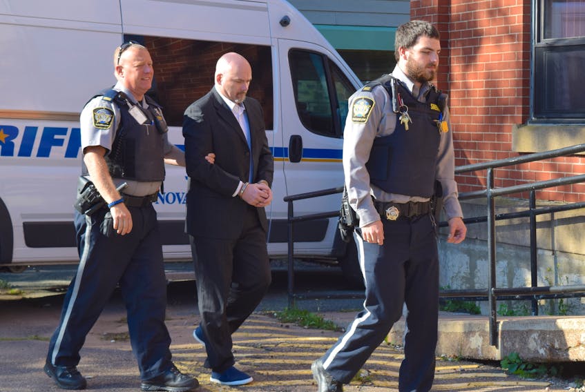 Ernie (Junior) Duggan, charged with first-degree murder in last September's death of his Bayhead neighbour Susan Butlin, is seen being led into Nova Scotia Supreme Court in Truro on Friday. Duggan's five-week judge and jury trial is set to begin next Sept. 16.