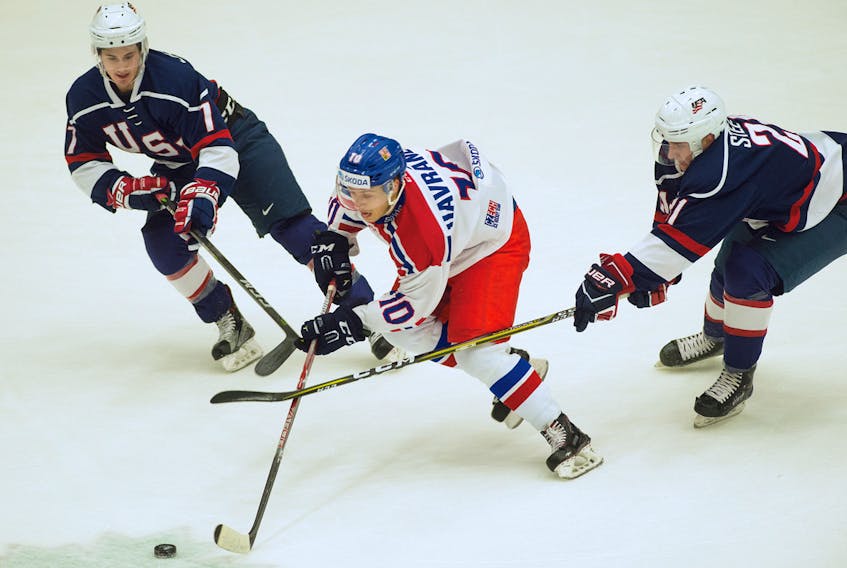Thomas Havranek (10) of the Czech Republic tries to break free from USA’s Graham Lillibridge, left, and Alex Steeves during first-period action of a World Junior A Challenge game at the RECC on Monday. Mark Goudge/SaltWire Network