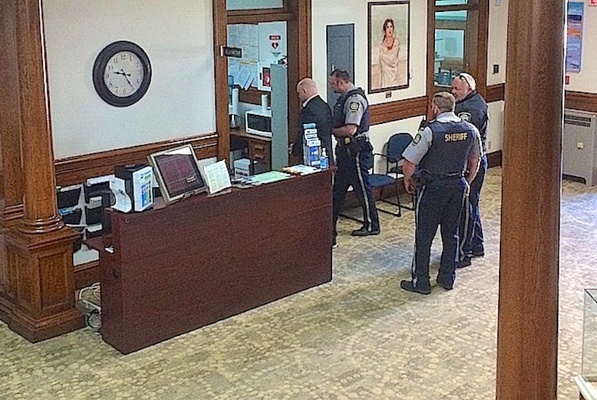 Ernie Ross Duggan of Bayhead, who is charged with first-degree murder, is seen being escorted by Sherrif's deputies towards an elevator enroute to a courtroom on the second floor of the Nova Scotia Supreme Court building Truro Wednesday morning.