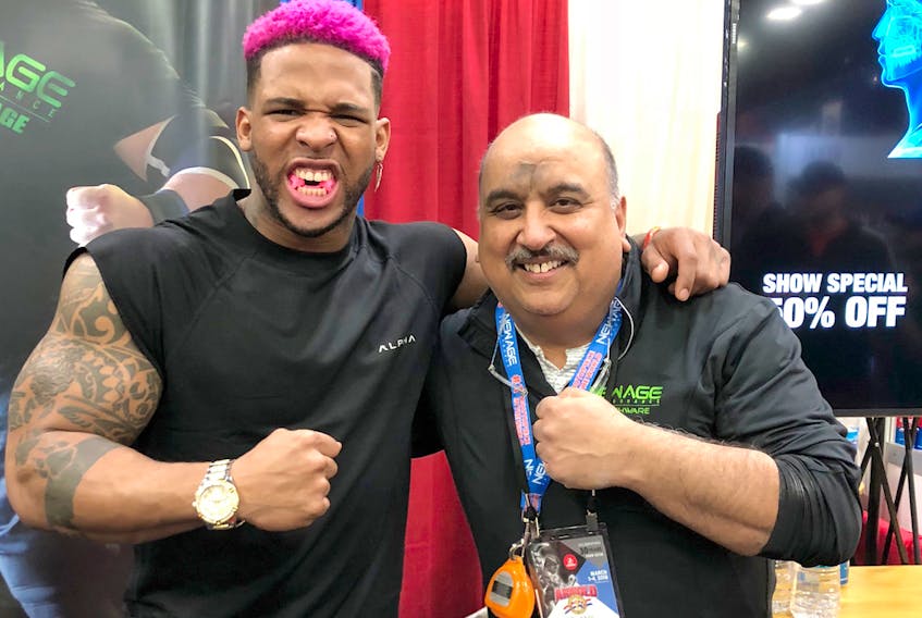 Truro dentist Dr. Anil Makkar, right, is seen with American fitness model Terron Beckham, cousin of New York Giants receiver Odell Beckham, during the 2018 Arnold Sports Festival in Columbus, Ohio. Beckham is sporting a New Age Performance mouthpiece.