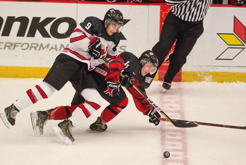 Nick Campoli (9) of Canada East and Canada West’s Riese Gaber fight for control of the puck during action in a quarterfinal game on Wednesday at the World Junior A Hockey Challenge in Truro. Mark Goudge/SaltWire Network