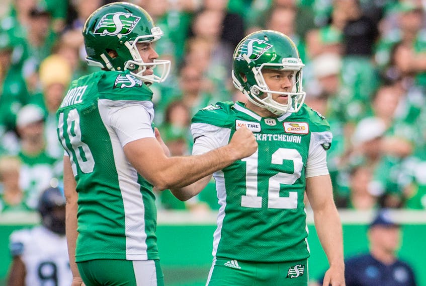 Brett Lauther, left, gets a high-five from teammate Ed Gainey during the Saskatchewan Roughriders victory over the Toronto Argonauts on Friday. Derek Mortensen/Electric Umbrella Images