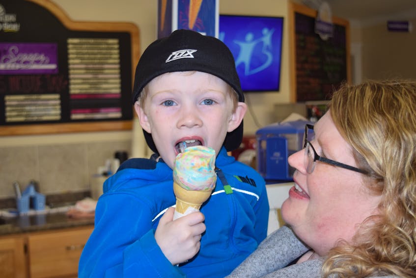 Little Carter Langille enjoys an ice cream with his mom Connie Smith, on the first day of business for the Fundy Scoop Dairy Bar. FRAM DINSHAW/TRURO NEWS