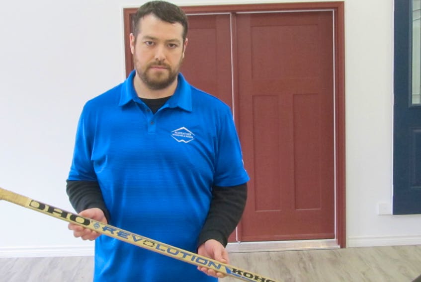 James Rutherford holds the hockey stick he was given 20 years ago following the Truro TSN Bearcats winning the Allan Cup.