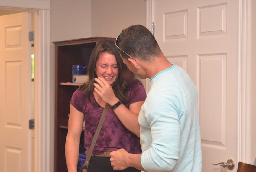 Anna Payson of Salmon River receives a hug from her dad, Troy, after being unable to contain her emotions when she was surprised with a $10,000 scholarship she received through her efforts as a Peer Mentor with Big Brothers Big Sisters of Colchester. HARRY SULLIVAN/TRURO NEWS