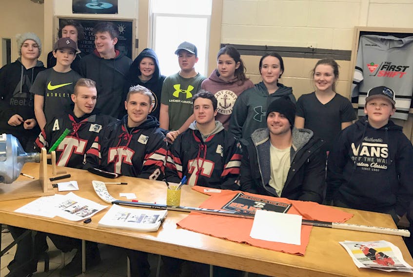Current members of the Truro Bearcats, front row, from left, Dylan Burton, Ryan Porter and Gavin Hart, along with former Bearcat Dana Fraser, recently instructed skills clinics for about 100 kids from the North Shore minor association.
