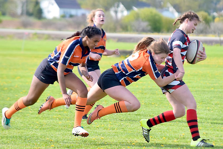 Rachel LeBlanc of the Cobequid Cougars tackles a member of the Northumberland Nighthawks during high school girls playoff rugby action on Tuesday. The Cougars earned a 17-5 victory in the Northumberland region semifinal game.