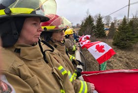 These firefighters joined others above Hwy 102, paying their respects to Skyler Blackie as the convoy carrying his remains returned to Truro from Amherst on March 23.