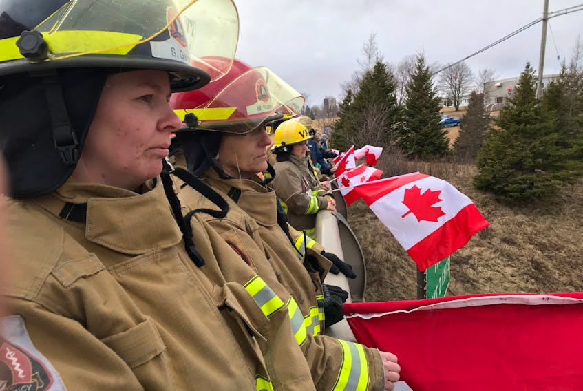 These firefighters joined others above Hwy 102, paying their respects to Skyler Blackie as the convoy carrying his remains returned to Truro from Amherst on March 23.