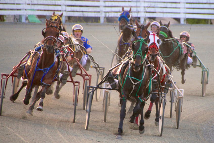 The horses were packed tight as they came around the turn in Race 5 at Truro Raceway Friday evening. Miss Sangria (wearing the white mask), with Gilles Barrieau driving, won the race in 1:58.2. Barrieau, a New Brunswick native, won three races during the evening’s Atlantic Driving Championship competition, and will advance to the National Driving Championship, being held in Ontario in September. Nova Scotia driver Redmond Doucet will also go on to the national competition.