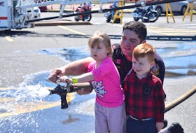 Firefighter Errison Blackie is a handy teacher, as he showed Hunter Embree and his friend Paeton Lewis how to operate a fire hose, during the Canada’s 911 Ride fundraiser in Truro on May 25. The event was held in the parking lot of Sobeys on 985 Prince Street.